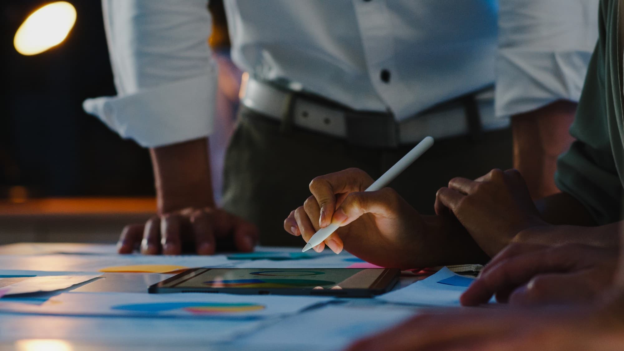 Team reviewing charts on a tablet during a planning session